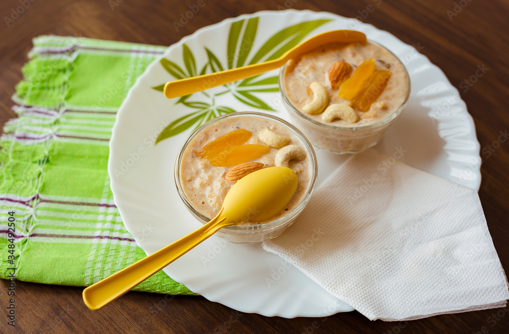 Cornflakes kheer or sweet pudding with dry fruits served in glass bowls Cornflakes kheer or sweet pudding with dry fruits served in glass bowls