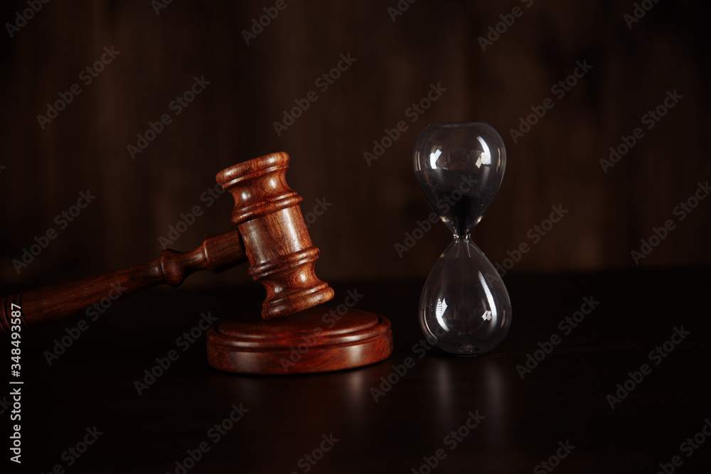 Court concept. Hourglass and judge gavel on table close up. Court concept. Hourglass and judge gavel on table close up.