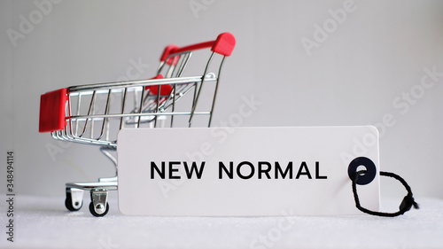 New Normal word with shopping cart, Coronavirus pandemic concept. photo