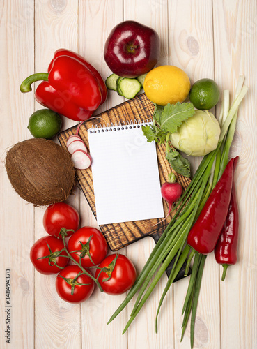 Blank notepad with fresh vegetables top view. Diet plan concept.