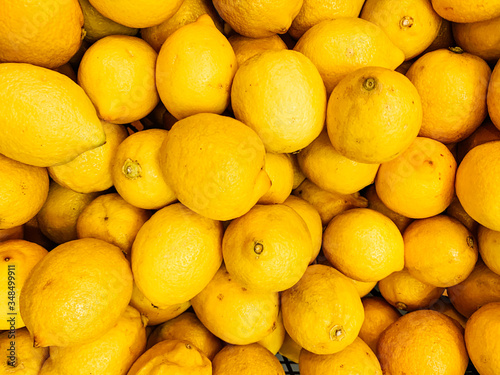 lots of ripe citrus yellow lemons for eating like a background