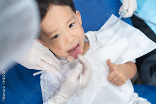 A boy having teeth examined at dentists  Healthy lifestyle  healthcare  and medicine concept.