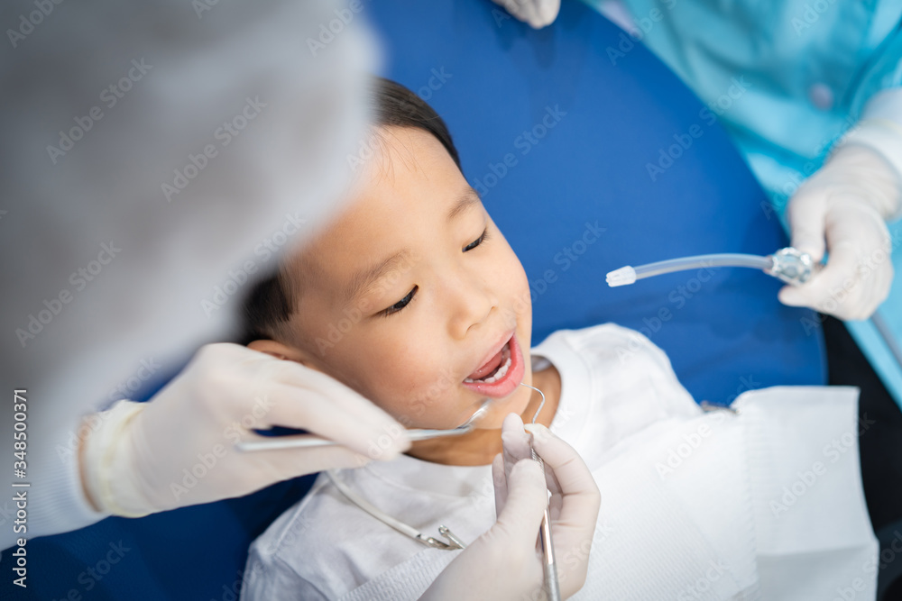 A boy having teeth examined at dentists: Healthy lifestyle, healthcare, and medicine concept. A boy having teeth examined at dentists: Healthy lifestyle, healthcare, and medicine concept.