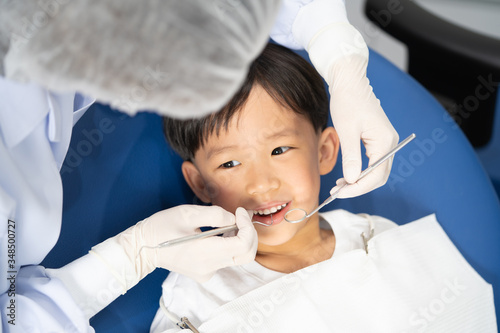 A boy having teeth examined at dentists  Healthy lifestyle  healthcare  and medicine concept.