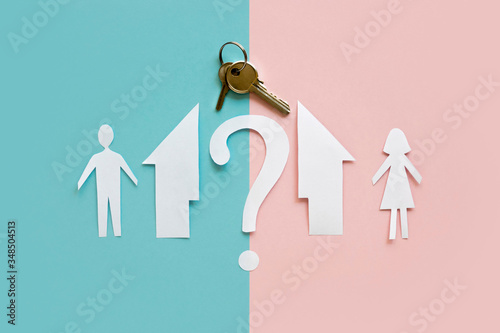 Flat lay paper family house separated with key. Divorce concept.