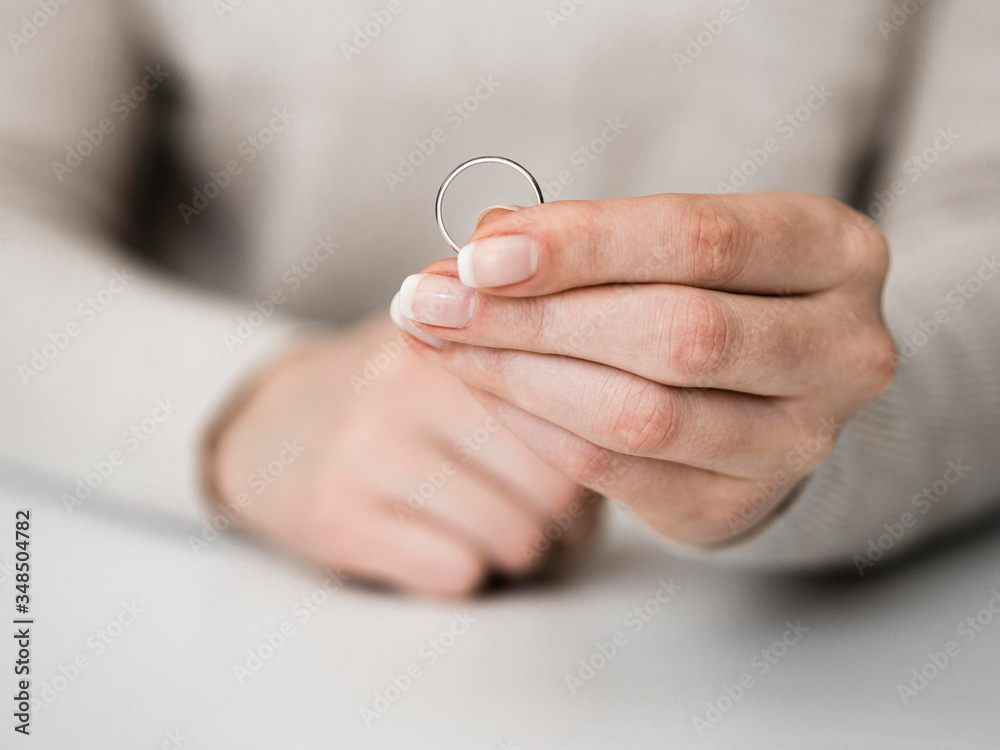 Woman holding marriage ring. Divorce. Woman holding marriage ring. Divorce.