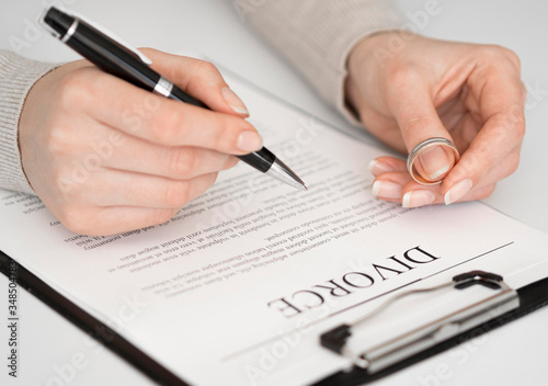Woman signing divorce settlement agreement