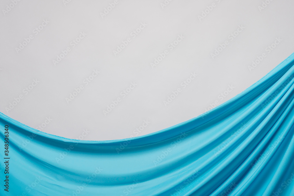 Obraz premium Close-up wrinkled blue fabric textile material with white background copy space