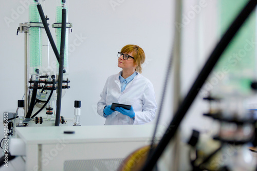 Scientist operating on rotavapor machine in during CBDa oil extraction