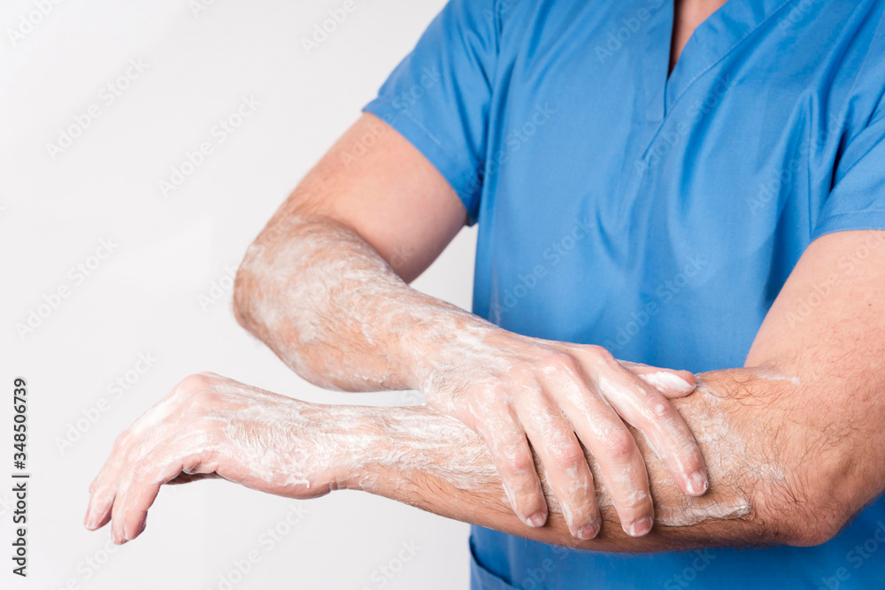 Close-up nurse disinfecting and washing arms and hands Close-up nurse disinfecting and washing arms and hands