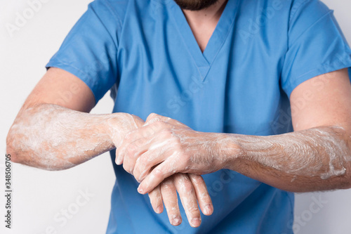 Close-up nurse disinfecting and washing hands