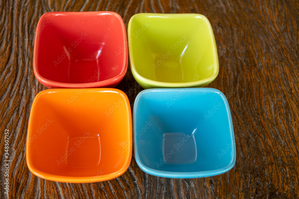 colorful dishes on wooden table colorful dishes on wooden table