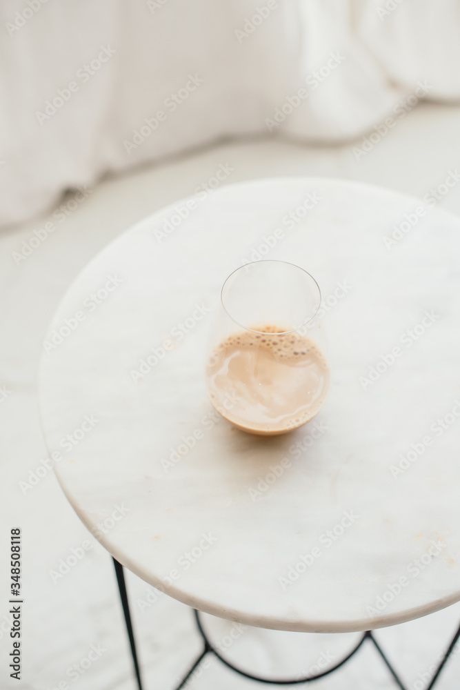 caffee late in a glass in a white minimalist room caffee late in a glass in a white minimalist room