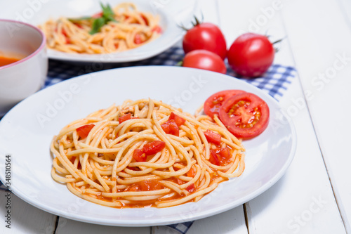 Spaghetti pasta with and tomato sauce on wood background