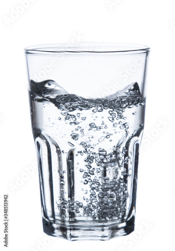pouring water on a glass on white background clipping path