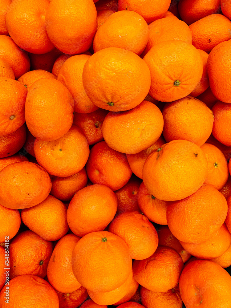 lots of ripe citrus yellow tangerines for eating like a background