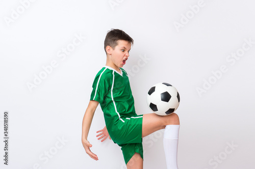 Kid play with soccer ball over white background. Kid activities.Training game concept.