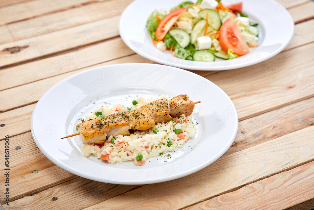 chicken kebab with rice and salad on the wooden background chicken kebab with rice and salad on the wooden background