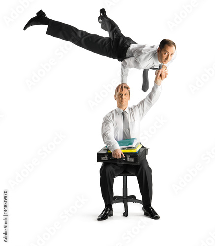 Business acrobats balancing in various poses on a white background. photo