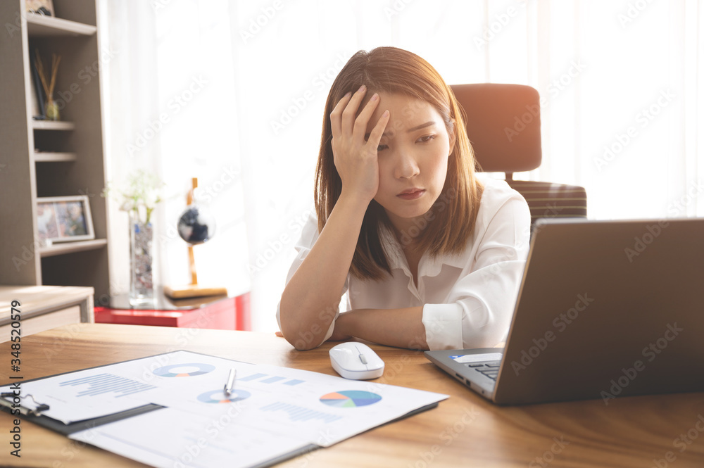 Stressed young Asian woman using laptop working at home Stressed young Asian woman using laptop working at home