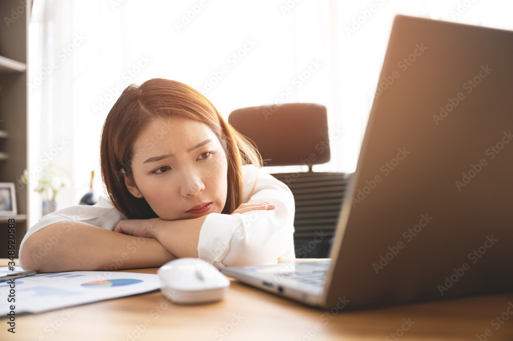 Stressed young Asian woman using laptop working at home Stressed young Asian woman using laptop working at home