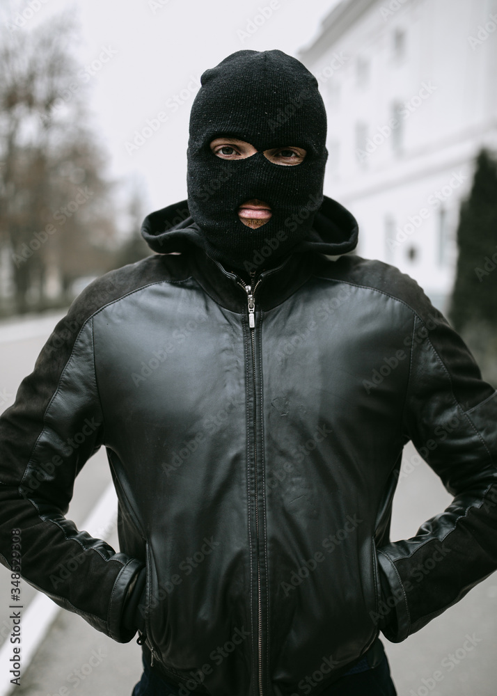 portrait of man thief in mask on the street portrait of man thief in mask on the street