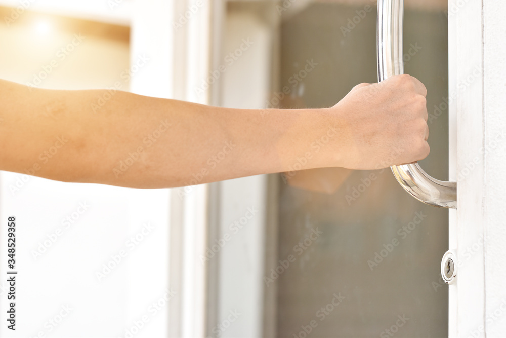 Close-up of man hand open the door holding handle.