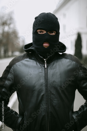 portrait of man thief in mask on the street