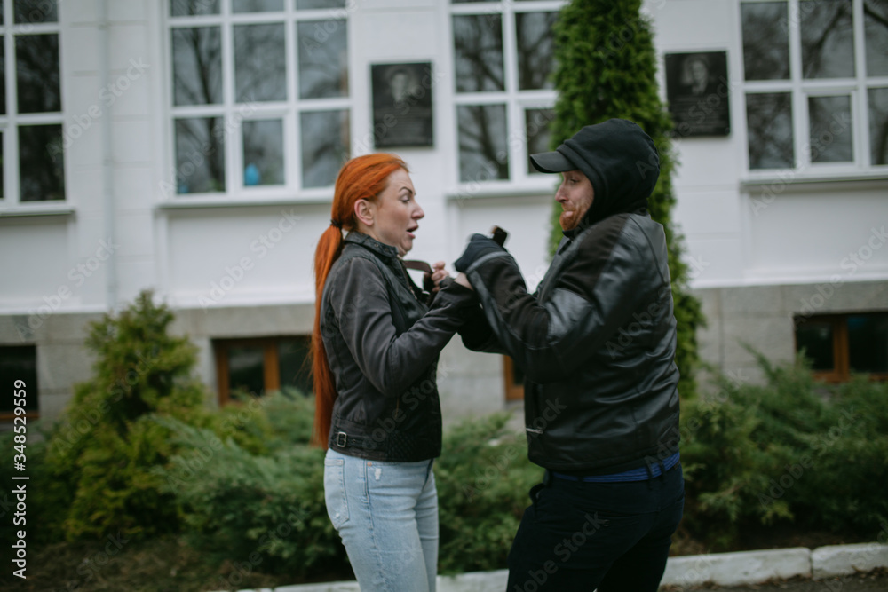 Young woman gets phone snatching on the street , Beware of mobile phone snatching thief, robbery on the street, soft focus Young woman gets phone snatching on the street , Beware of mobile phone snatching thief, robbery on the street, soft focus