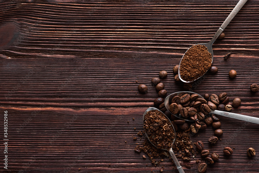 Roasted black coffee beans of different fractions on a dark table Roasted black coffee beans of different fractions on a dark table
