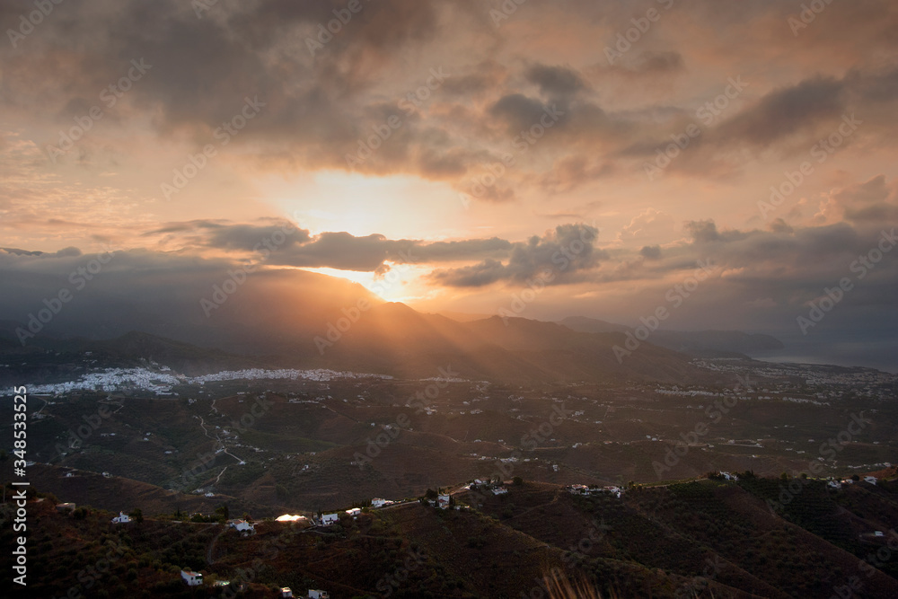 Sun rising over the Town of  Frigiliana, Malaga Province, Axarquia, Andalusia, southern Spain.