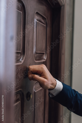 Partial view of collector knocking on door with hand Fototapete