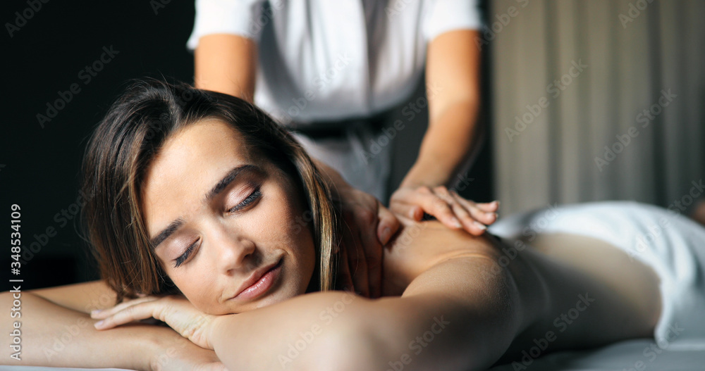 Masseur doing massage on woman body in the spa salon. Beauty treatment concept. Masseur doing massage on woman body in the spa salon. Beauty treatment concept.