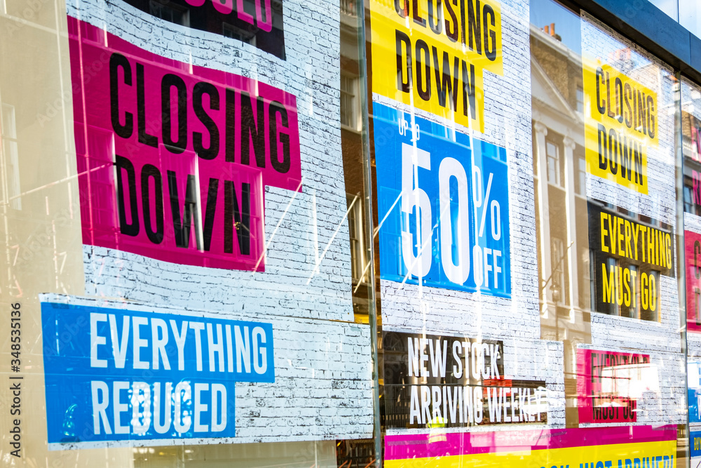 Retail store closing down 'reduced, everything must go' signs in shop