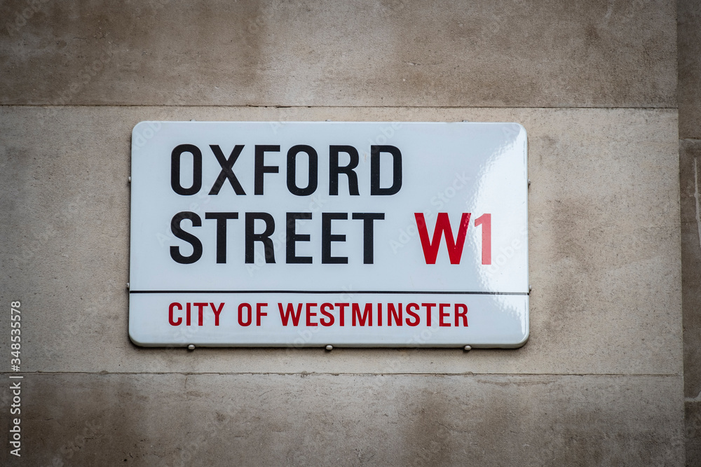 LONDON- NOVEMBER, 2019: Oxford Street sign- a landmark shopping street in London's West End LONDON- NOVEMBER, 2019: Oxford Street sign- a landmark shopping street in London's West End