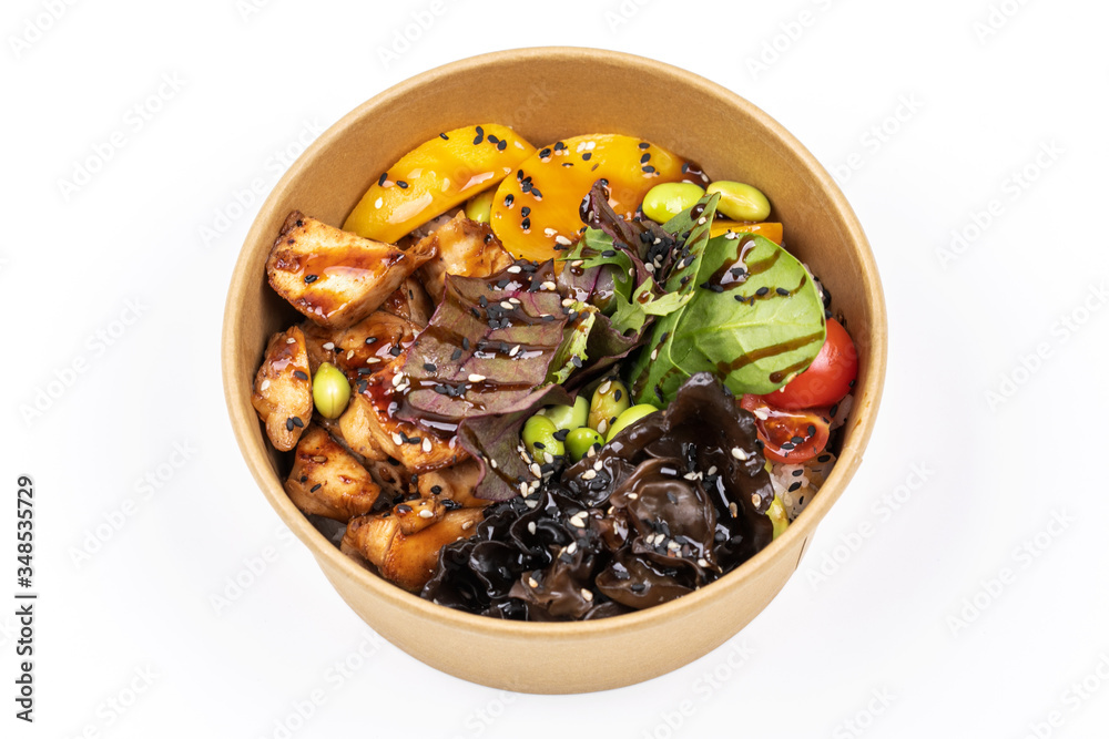 Poke bowl with chicken and vegetables on the white table. Poke bowl with chicken and vegetables on the white table.