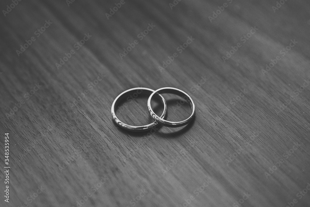 wedding rings on a wooden table in black and white wedding rings on a wooden table in black and white