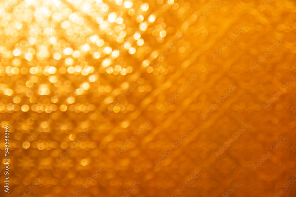 Defocus yellow bokeh background. Shine and glow texture for decoration of holidays and beauty products. Summer sun concept.