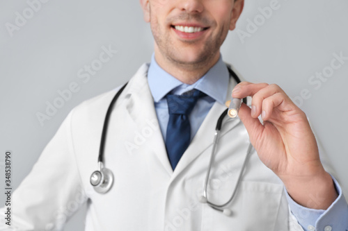 Male doctor with flashlight...