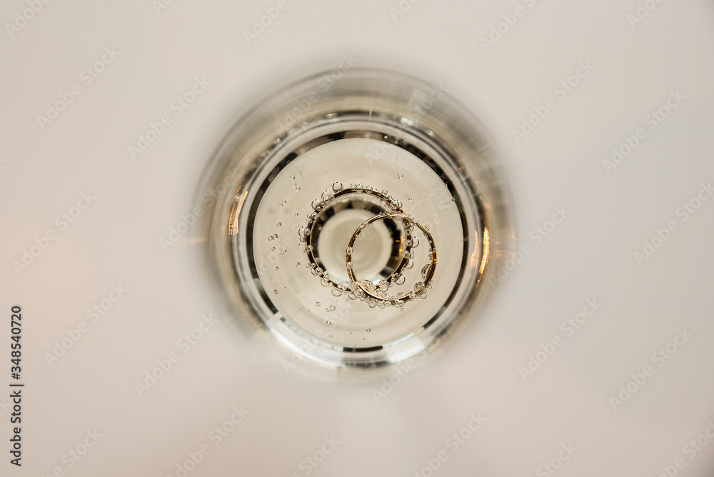 wedding rings in a glass of champagne wedding rings in a glass of champagne
