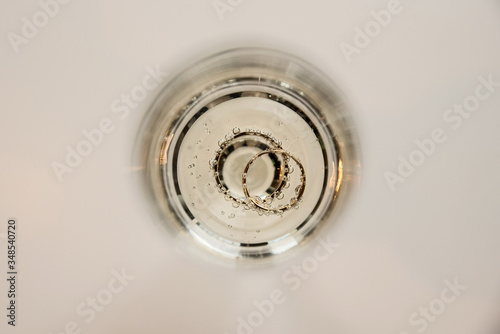 wedding rings in a glass of champagne