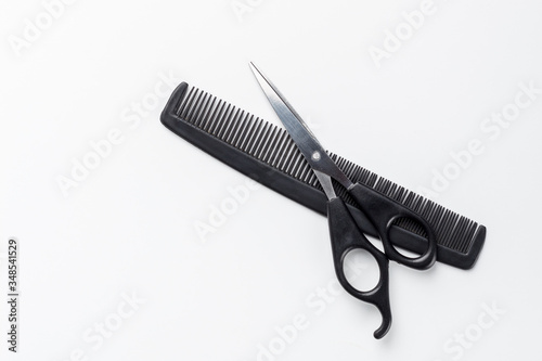 scissors and comb on a white background