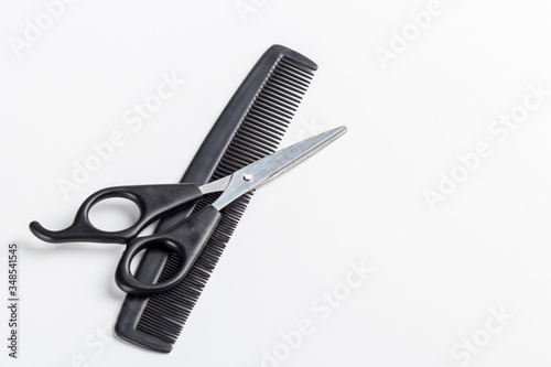 scissors and comb on a white background. Place for text