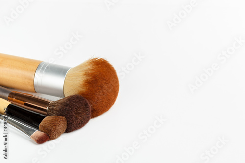 Makeup brushes of different sizes on a white background