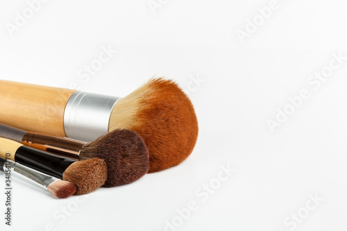 Makeup brushes of different sizes on a white background