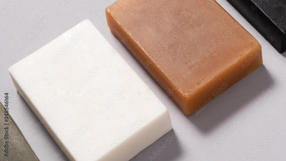 Set of different handmade soap on black background