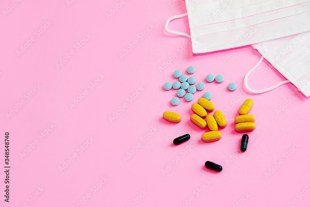 medical masks and tablets on a pink background medical masks and tablets on a pink background