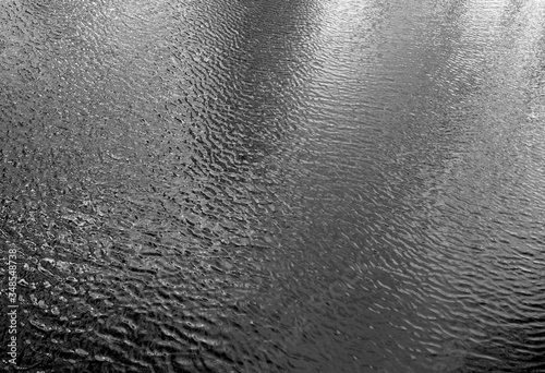 Waves on lake water from top. Black and white
