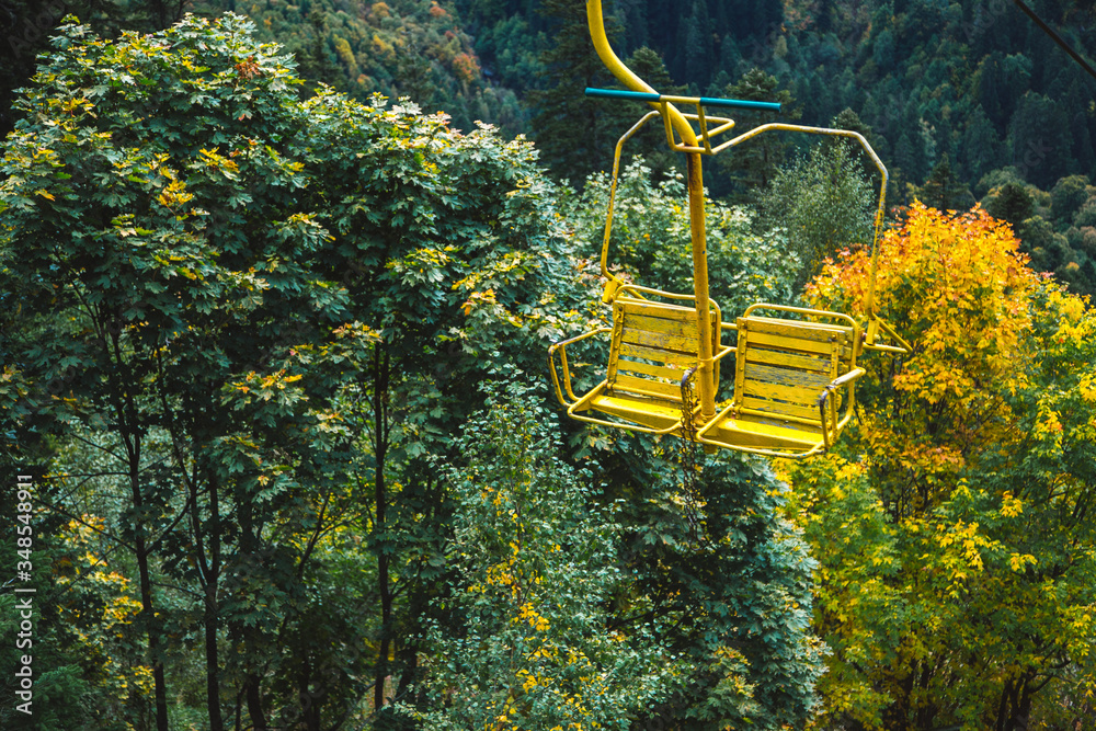 Old chairlift cableway in Dombay ski resort from the Mount Mussa Achitara in autumn, beautiful mountains landscape, Caucasus, Russia Old chairlift cableway in Dombay ski resort from the Mount Mussa Achitara in autumn, beautiful mountains landscape, Caucasus, Russia