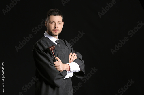 Male judge on dark background